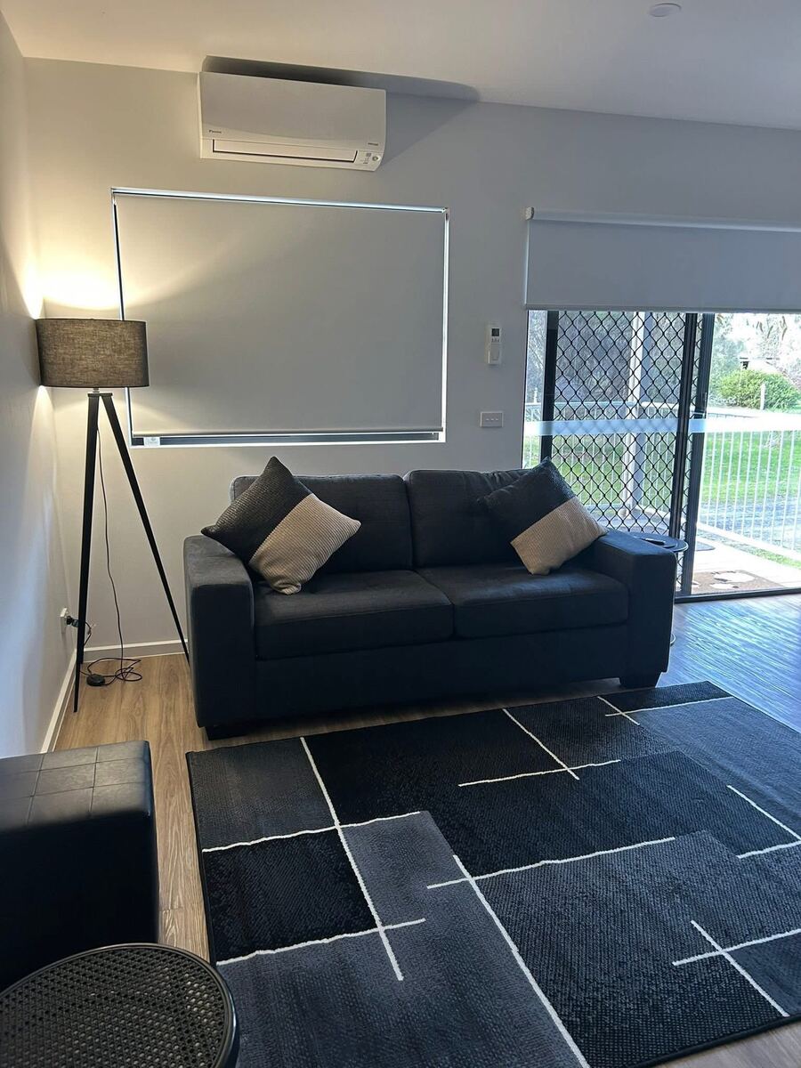 Cabin living area with sofa and outlook to the grounds